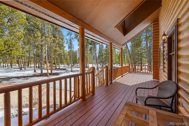snow covered deck featuring covered porch