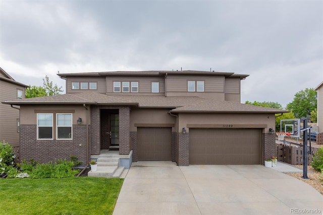 11880 W 38th Pl, Wheat Ridge, CO 80033 - prairie-style house with concrete driveway, a front lawn, stucco siding, and a garage