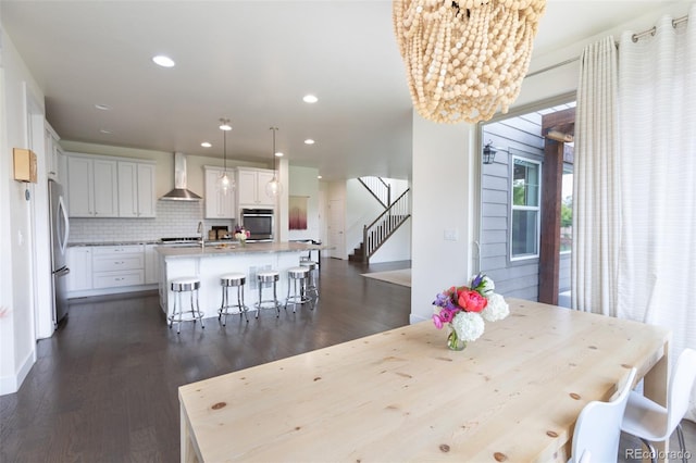 11880 W 38th Pl, Wheat Ridge, CO 80033 - dining space with dark wood-style flooring, stairway, a chandelier, and recessed lighting