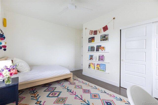 11880 W 38th Pl, Wheat Ridge, CO 80033 - bedroom with wood finished floors, baseboards, a ceiling fan, and a closet