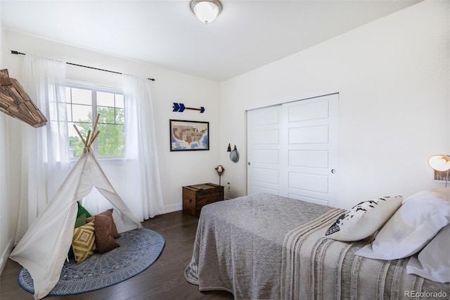11880 W 38th Pl, Wheat Ridge, CO 80033 - bedroom featuring wood finished floors, a closet, and baseboards