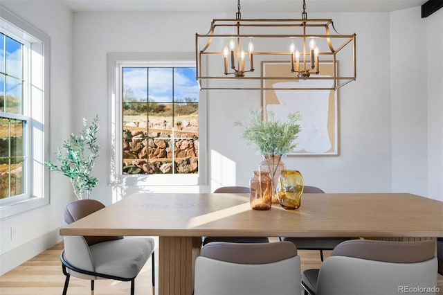 dining space featuring an inviting chandelier and light wood-style floors