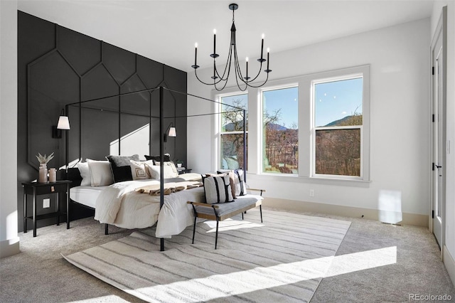 carpeted bedroom featuring an inviting chandelier and baseboards