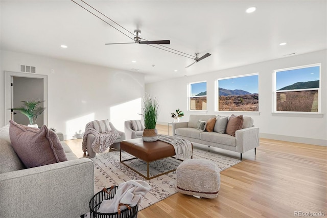 living area featuring recessed lighting, visible vents, plenty of natural light, and wood finished floors