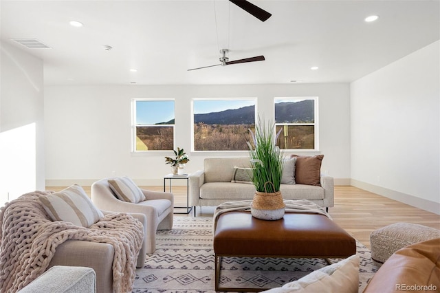 living area with recessed lighting, visible vents, ceiling fan, and light wood-style floors