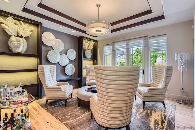 9470 S Silent Hills Dr, Lone Tree, CO 80124 - living area with a raised ceiling, wood finished floors, and baseboards