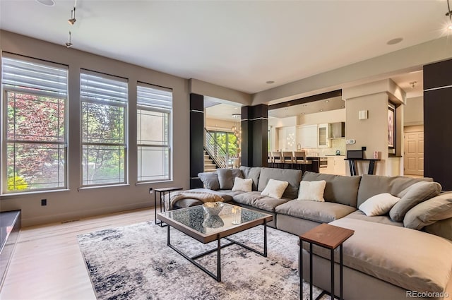 9470 S Silent Hills Dr, Lone Tree, CO 80124 - living room with light wood-type flooring, stairway, and baseboards