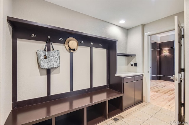 9470 S Silent Hills Dr, Lone Tree, CO 80124 - mudroom with light tile patterned floors and a textured wall