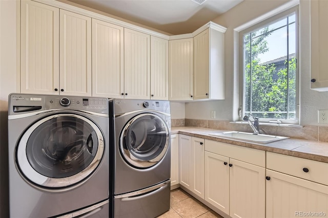 9470 S Silent Hills Dr, Lone Tree, CO 80124 - laundry room featuring cabinet space, washing machine and clothes dryer, and light tile patterned floors