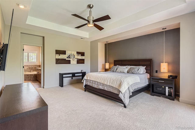 9470 S Silent Hills Dr, Lone Tree, CO 80124 - bedroom with a tray ceiling, carpet, baseboards, connected bathroom, and a ceiling fan
