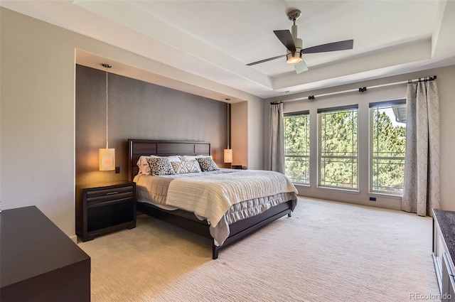 9470 S Silent Hills Dr, Lone Tree, CO 80124 - bedroom with a tray ceiling, light carpet, and ceiling fan