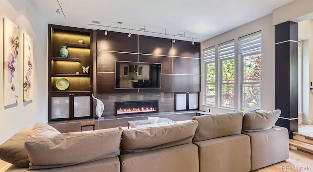 9470 S Silent Hills Dr, Lone Tree, CO 80124 - living area with rail lighting, a fireplace, and wood finished floors