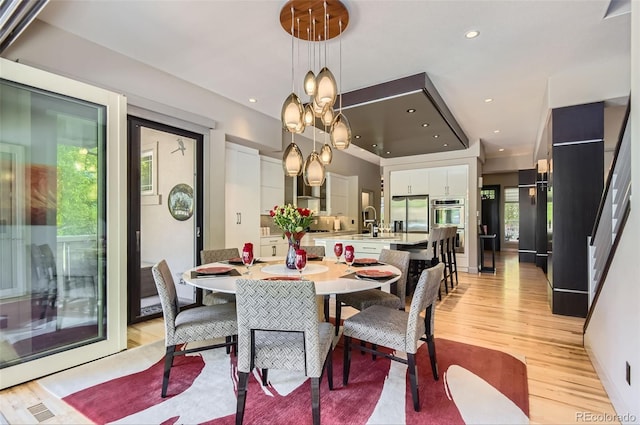 9470 S Silent Hills Dr, Lone Tree, CO 80124 - dining space featuring light wood-style floors, healthy amount of natural light, recessed lighting, and a chandelier