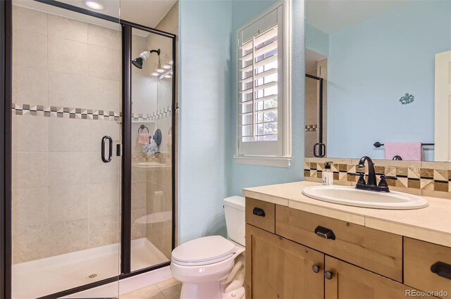 9470 S Silent Hills Dr, Lone Tree, CO 80124 - full bathroom with toilet, vanity, a stall shower, and tile patterned flooring