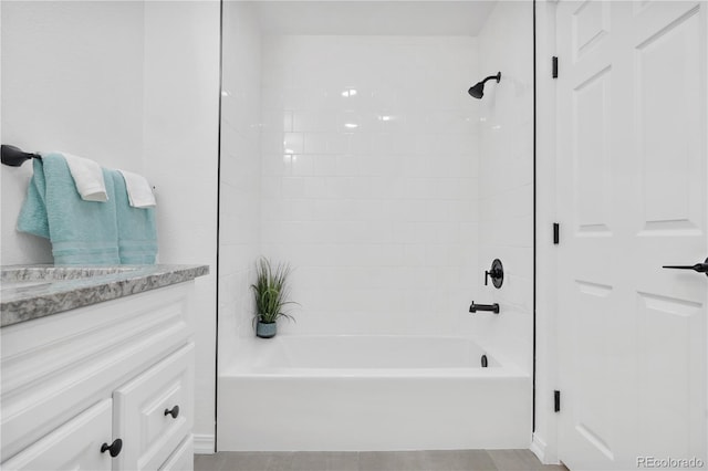 bathroom featuring vanity, tile patterned flooring, and  shower combination