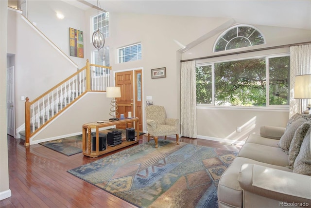 2935 Bow Line Pl, Longmont, CO 80503 - living room with stairs, wood-type flooring, a chandelier, baseboards, and high vaulted ceiling