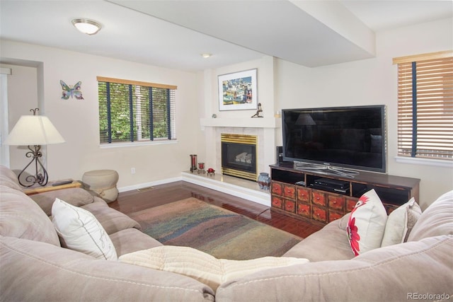 2935 Bow Line Pl, Longmont, CO 80503 - living area featuring wood finished floors, baseboards, and a glass covered fireplace