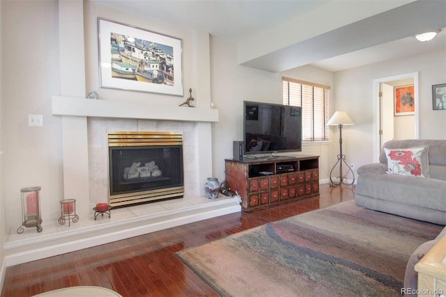 2935 Bow Line Pl, Longmont, CO 80503 - living area with hardwood / wood-style flooring, baseboards, and a tiled fireplace