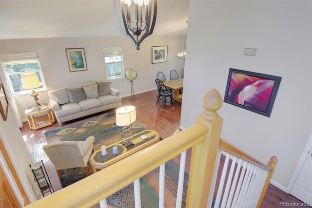 2935 Bow Line Pl, Longmont, CO 80503 - living room featuring a chandelier, wood finished floors, and baseboards