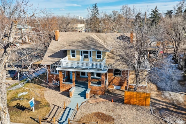 1602 11th Ave, Greeley, CO 80631 - view of front facade featuring a chimney, view of wooded area, a patio area, and a deck