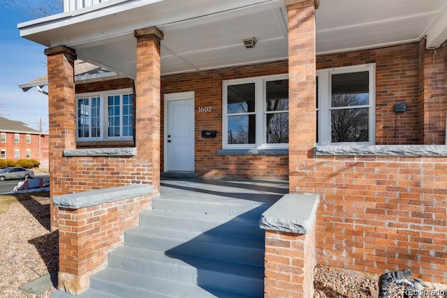 1602 11th Ave, Greeley, CO 80631 - doorway to property with brick siding and covered porch
