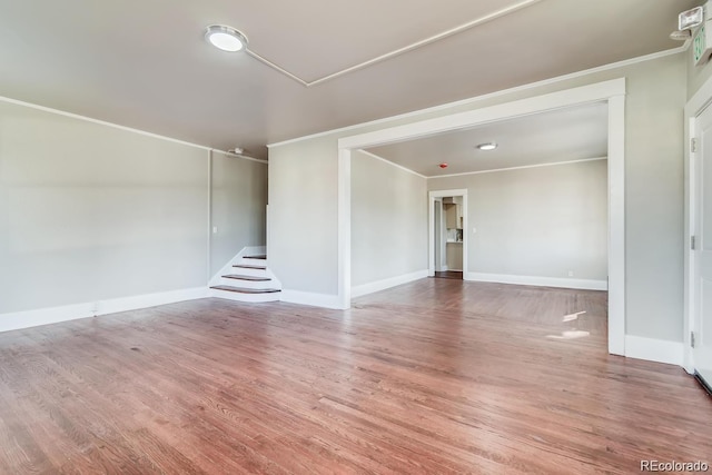 1602 11th Ave, Greeley, CO 80631 - unfurnished living room featuring wood finished floors and ornamental molding