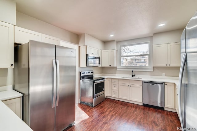 1602 11th Ave, Greeley, CO 80631 - kitchen with appliances with stainless steel finishes, light countertops, dark wood finished floors, white cabinets, and recessed lighting