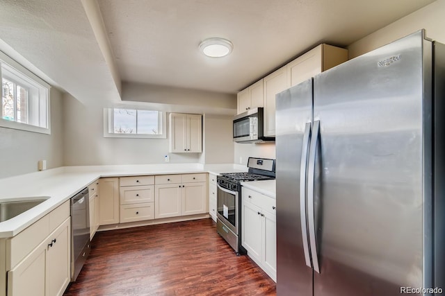 1602 11th Ave, Greeley, CO 80631 - kitchen with appliances with stainless steel finishes, dark wood-style floors, light countertops, and white cabinets