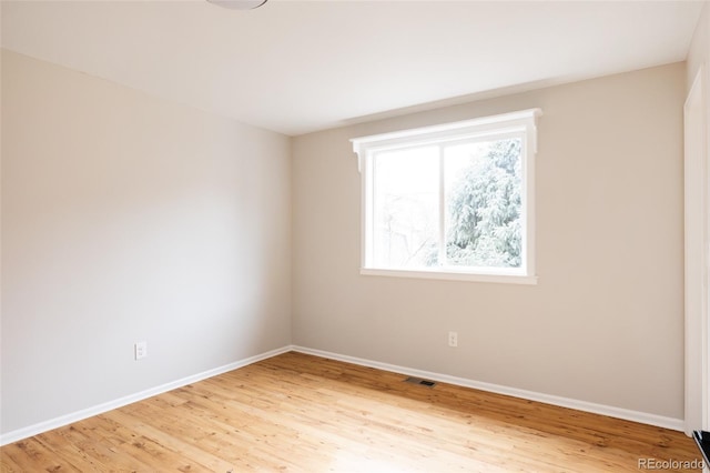 spare room with light hardwood / wood-style flooring