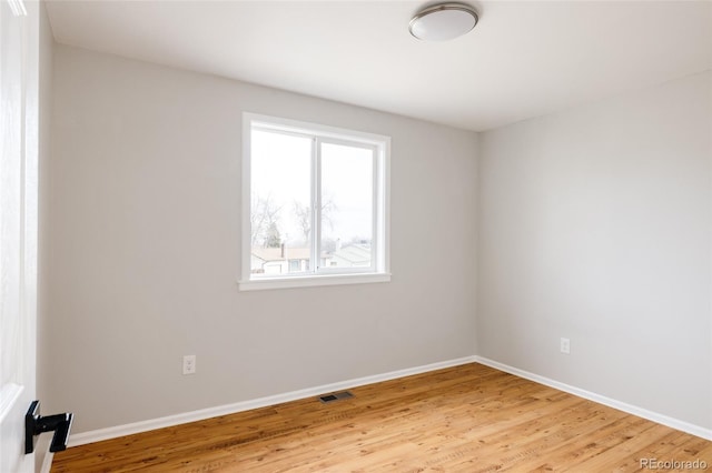 empty room with hardwood / wood-style flooring