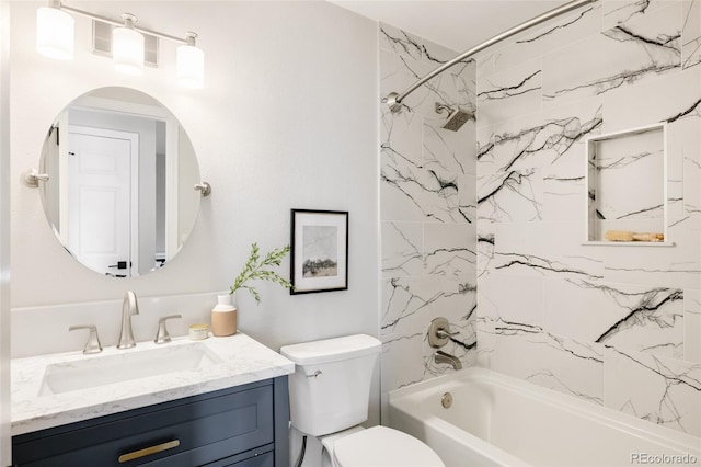 full bathroom with vanity, tiled shower / bath, and toilet