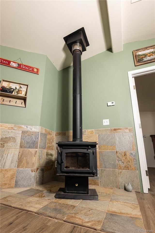 3130 Elk Park Rd, San Luis, CO 81152 - detailed view of a wood stove, wood finished floors, and beamed ceiling