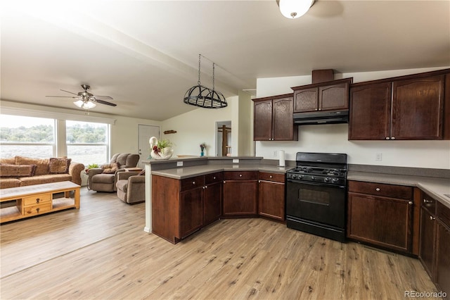 3130 Elk Park Rd, San Luis, CO 81152 - kitchen featuring black gas range oven, under cabinet range hood, a peninsula, vaulted ceiling, and a ceiling fan