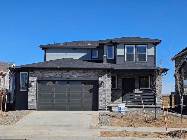 view of front of house featuring an attached garage, stone siding, covered porch, and concrete driveway