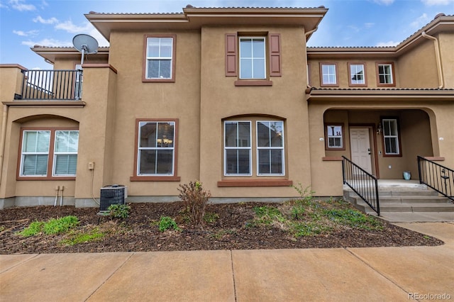 7777 E 23rd Ave Unit 1406, Denver, CO 80238 - rear view of house with stucco siding, a balcony, and central air condition unit