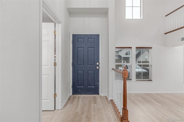 7777 E 23rd Ave Unit 1406, Denver, CO 80238 - foyer with light wood-style floors, a high ceiling, and baseboards