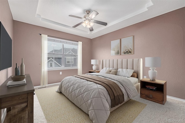 7777 E 23rd Ave Unit 1406, Denver, CO 80238 - bedroom with a tray ceiling, carpet, baseboards, ceiling fan, and a textured wall