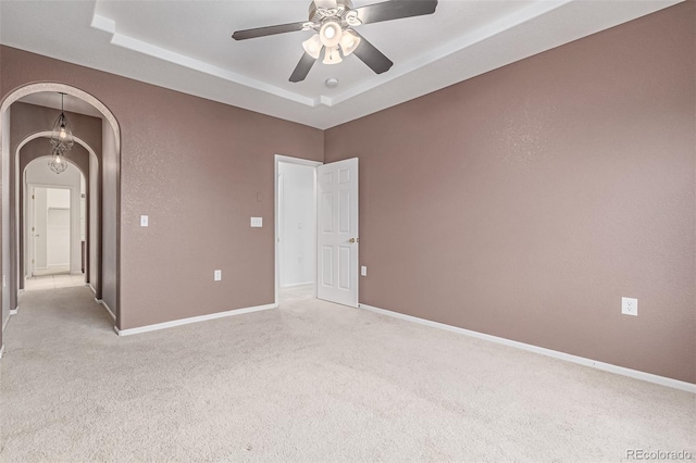 7777 E 23rd Ave Unit 1406, Denver, CO 80238 - empty room featuring light colored carpet, a ceiling fan, arched walkways, and a raised ceiling