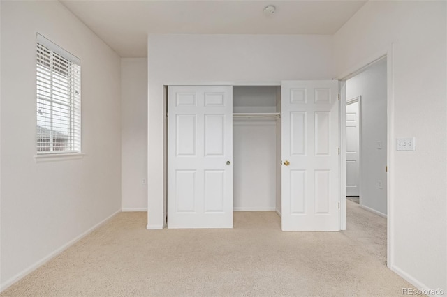 7777 E 23rd Ave Unit 1406, Denver, CO 80238 - unfurnished bedroom featuring carpet floors, a closet, and baseboards