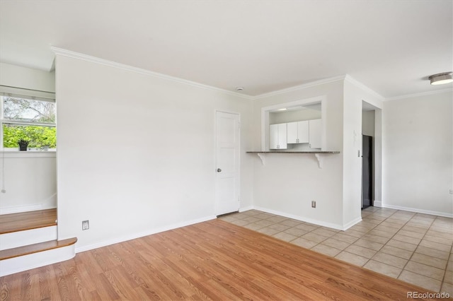 unfurnished living room with crown molding, light wood-style flooring, and baseboards
