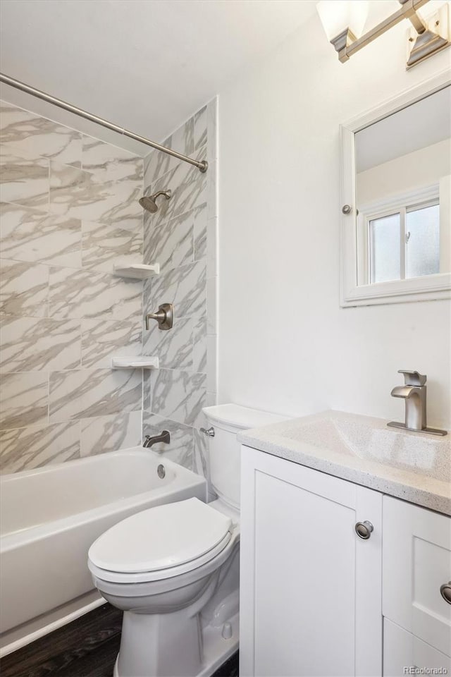 bathroom with vanity, toilet, and shower / washtub combination