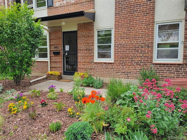 1165 Krameria St, Denver, CO 80220 - view of exterior entry featuring brick siding and stucco siding