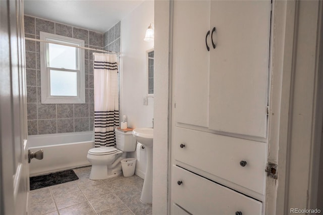 bathroom featuring shower / bath combination with curtain, tile patterned floors, and toilet