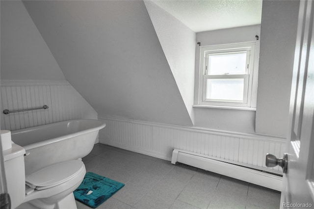 bathroom featuring a baseboard radiator, toilet, a textured ceiling, and a washtub