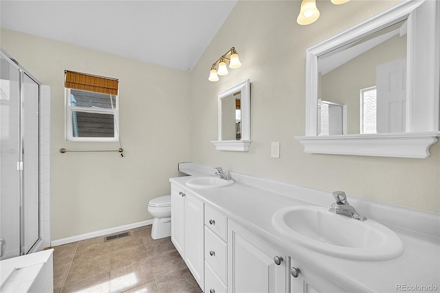 bathroom featuring a sink, vaulted ceiling, and visible vents