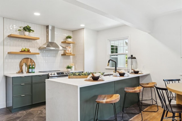 4465 N Umatilla St, Denver, CO 80211 - kitchen featuring wall chimney range hood, open shelves, green cabinets, a kitchen breakfast bar, and recessed lighting