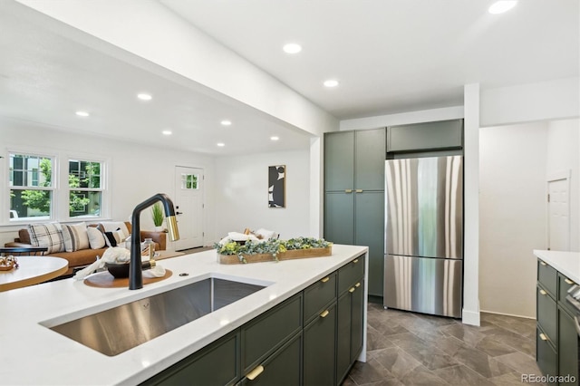 4465 N Umatilla St, Denver, CO 80211 - kitchen with freestanding refrigerator, green cabinetry, light countertops, and recessed lighting
