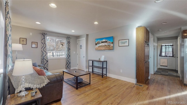 living room with light hardwood / wood-style flooring