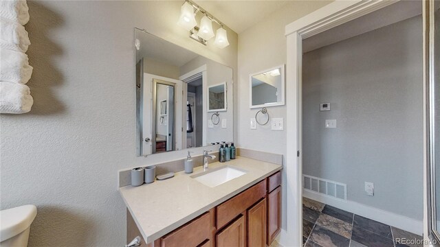 bathroom with vanity and toilet