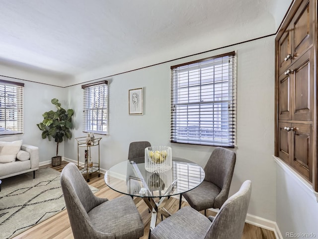 dining area featuring a healthy amount of sunlight and light hardwood / wood-style floors